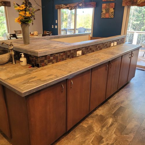 Kitchen (second floor): the kitchen island between the kitchen and the dining area. (the stairwell down the basement is in the middle of the island. )