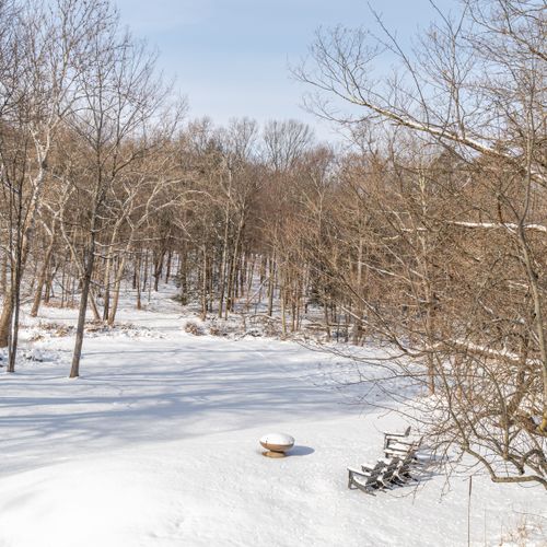 The beautiful snow filled backyard and fire pit