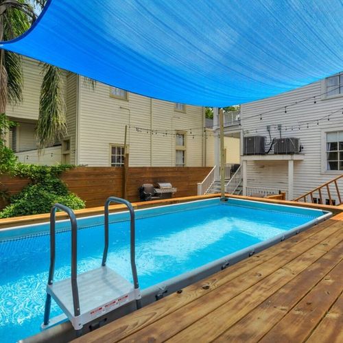 Pool nestled in a lush, fenced backyard — your own quiet oasis.