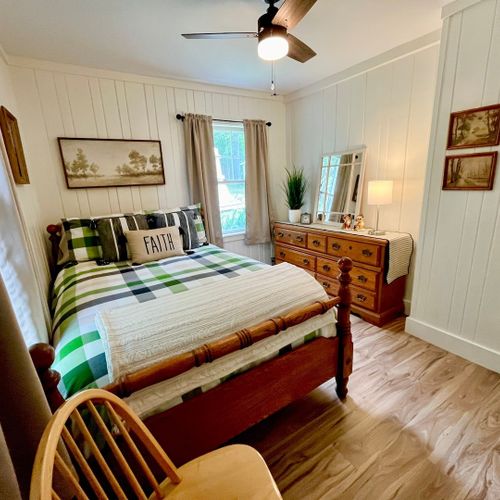Bedroom #1:  features a queen-size bed, dresser, and chair.
