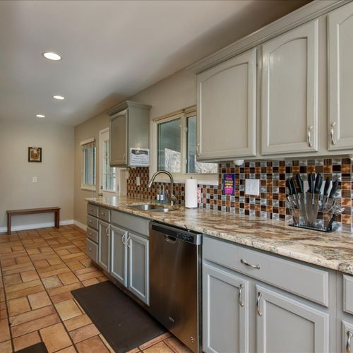 The galley kitchen space highlights contemporary counters and modern appliances.