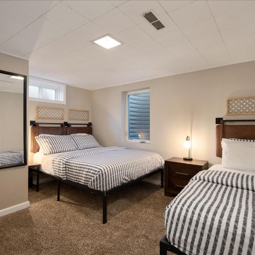 The spacious basement bedroom has a queen and a single bed.