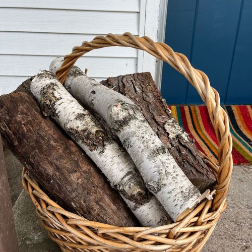 Exterior:  firewood at the front of the cabin.