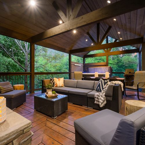 The outdoor covered patio has oversized outdoor sofas and extra lounging chairs.