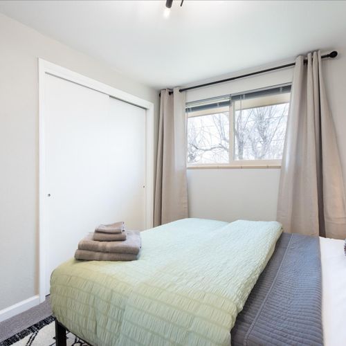 The second bedroom has a queen-sized bed, nightstands, a bench, luggage rack, and plenty of space for your belongings.