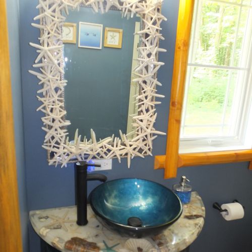 Bedroom #2:  consistent with the nautical theme in the bedroom, the bedroom has its own nautical-themed bathroom! (this is a private bathroom connected to the bedroom. )  this photo shows the gorgeous mirror, sink, and vanity in the bathroom.