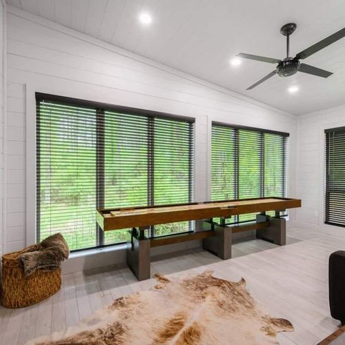 Shuffleboard and floor to ceiling windows.