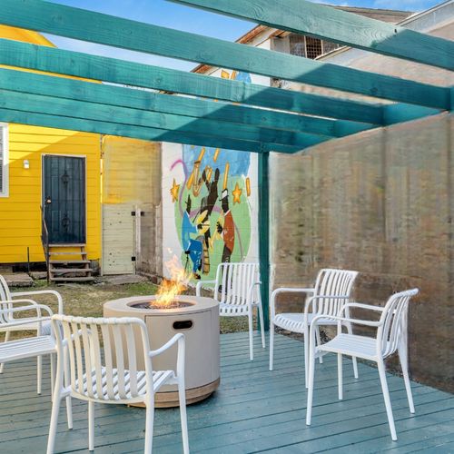 Covered courtyard w/ dining seating — a breezy spot for outdoor lounging & meals.