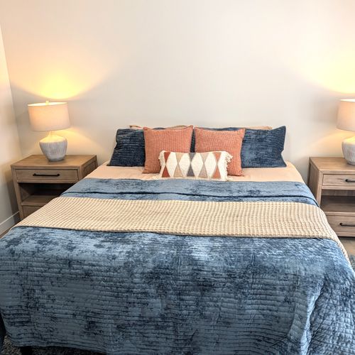 BEDROOM #1 (PRIMARY BEDROOM, MAIN FLOOR):  This is large and beautiful bed featuring a king-size bed, private ensuite full bathroom, private television, dresser, chair, ceiling fan, and closet.