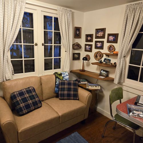 Living room:  the cabin has a cute little living room with a loveseat, dining table, and streaming television.
