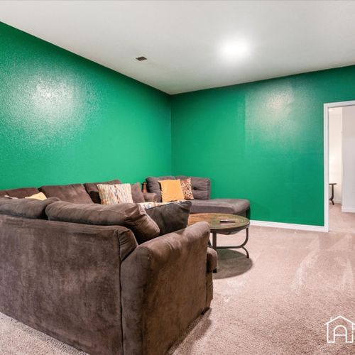 Kick back and unwind in the spacious downstairs lounge, featuring a large tv and plenty of seating for everyone.