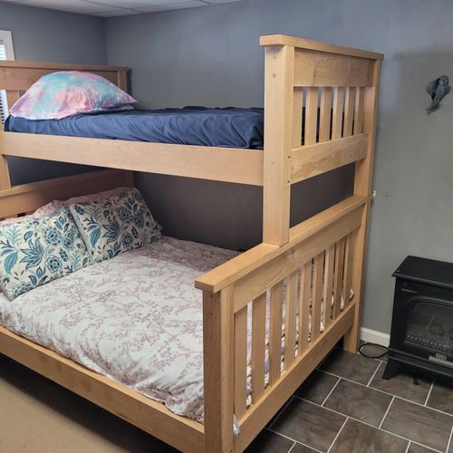 Bedroom:  cute bedroom with a twin-on-full bunk bed, electric heater, fan, 2 dressers, closet, lamp, and a television.