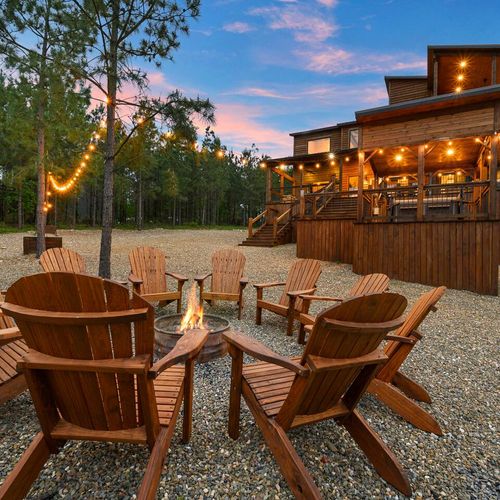 The fire pit with Adirondack chairs surrounding!
