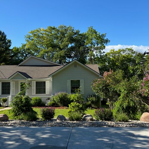 Exterior:  a broader view of the front of the house showing the parking area.