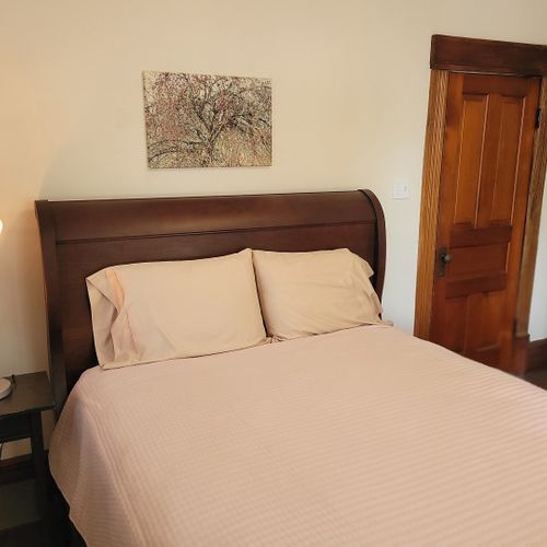 Bedroom #3 (second floor):  features a queen-size bed, dresser, large mirror, nightstand, and closet.