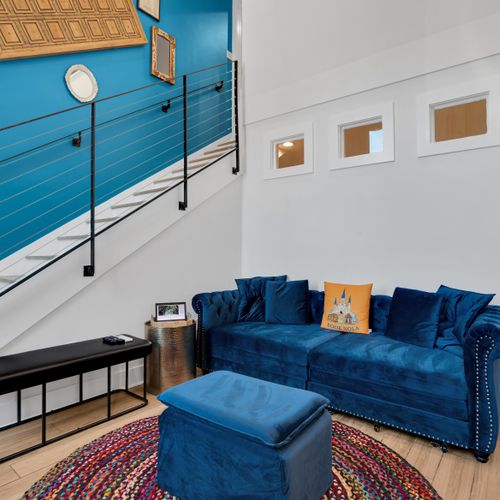 Kick back on blue velvet sofas in a bold, character-filled living room.