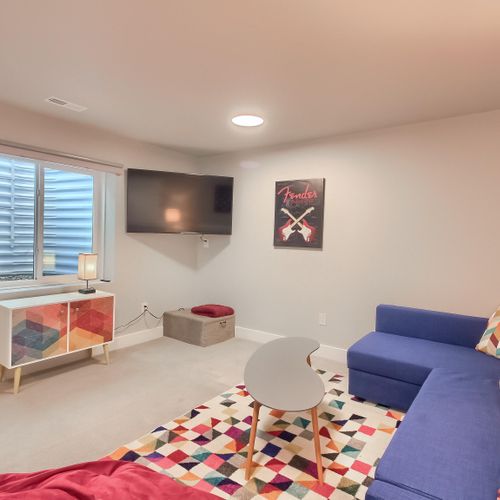 - watch your favorite shows on the wall mounted tv from the comfort of a bold blue sofa