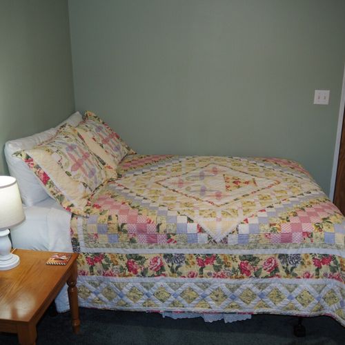 Bedroom #2:  one of the two full-size beds in the bedroom and the bedroom door.