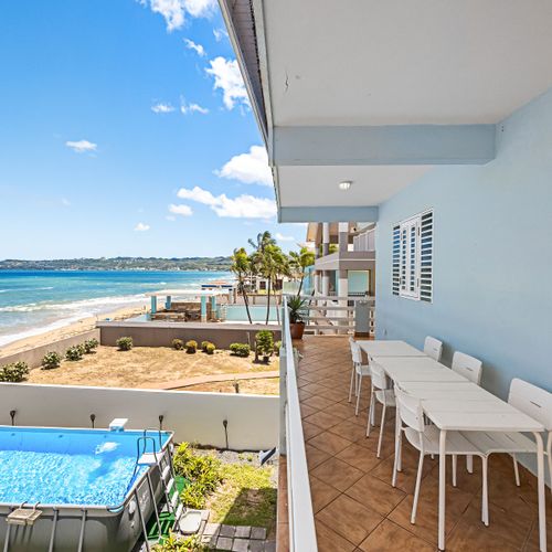 Direct oceanfront views from your spacious balcony with outdoor dining and pool!