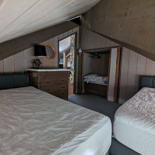 Bedroom #2:  one of the two upstairs bedrooms with two twin beds, a dresser, and a closet with extra blankets and pillows