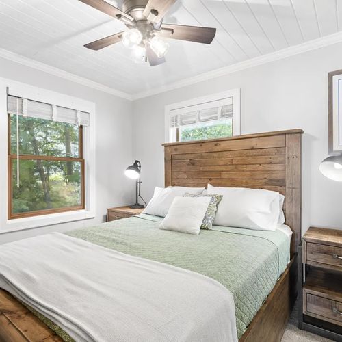 BEDROOM #4 (UPPER LEVEL):  Beautiful upper level bedroom with a queen-size bed, nightstands, lamps, ceiling fan, mirror, dresser, and closet