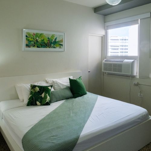 This well-appointed room offers both comfort and convenience, featuring a cozy bed and essential amenities nearby, ensuring a seamless and enjoyable stay.