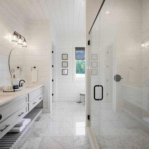 Attached private bathroom with double vanity, walk-in shower and tub.