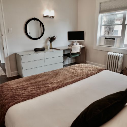 Fresh bedding and a sleek work corner.