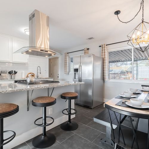 - stylish kitchen with granite countertops and sleek stainless appliances
- island seating and a fully set dining table make every meal feel like an occasion
- natural light, modern lighting, and clean finishes bring warmth and function together