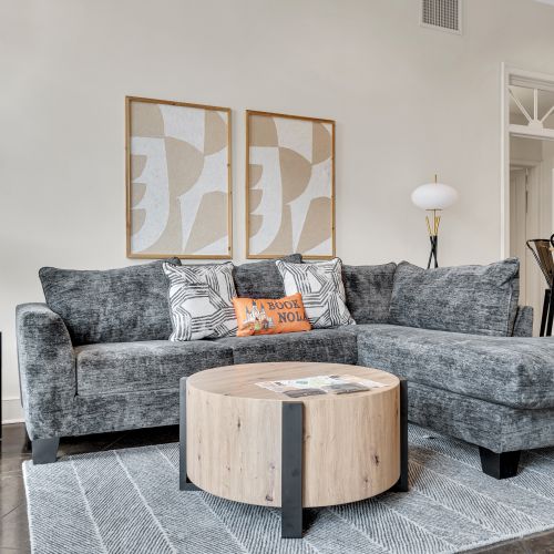 Lounge on the sofa beneath warm art & colorful accent pillows.