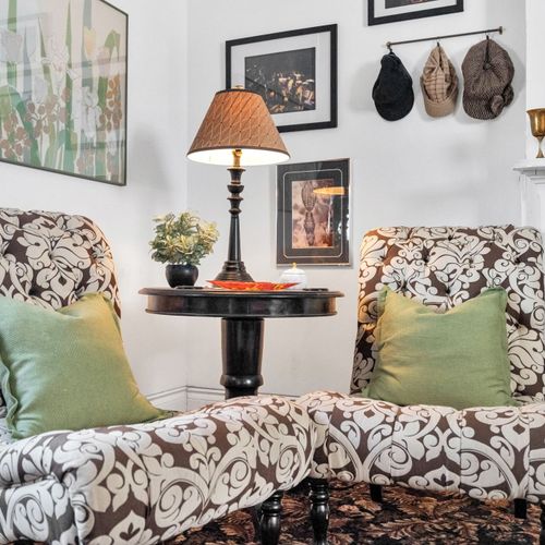 Intimate seating nook w/ lush greenery for quiet moments.