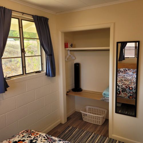 Bedroom #1:  features a queen-size bed, nightstands, lamps, mirror, and closet.