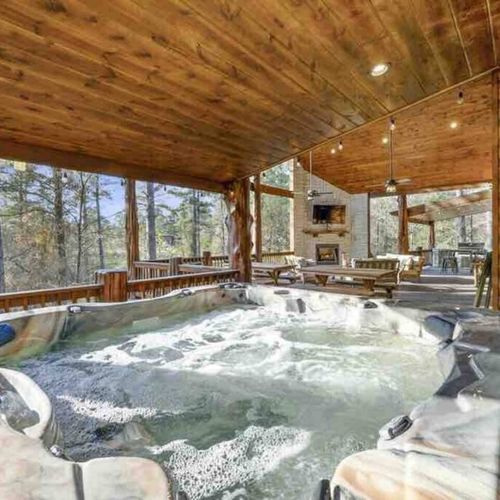Large outdoor hot tub ready to warm you up in the chilly night time air.