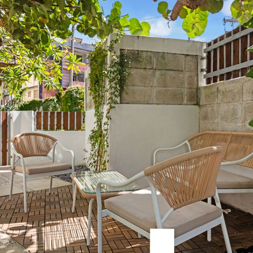 Relax in style at our cozy outdoor lounge with modern tropical chairs perfect for morning coffee or evening cocktails.