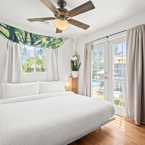 Sleep fresh in style—surrounded by indoor plants, clean design, and outdoor freshness right outside.