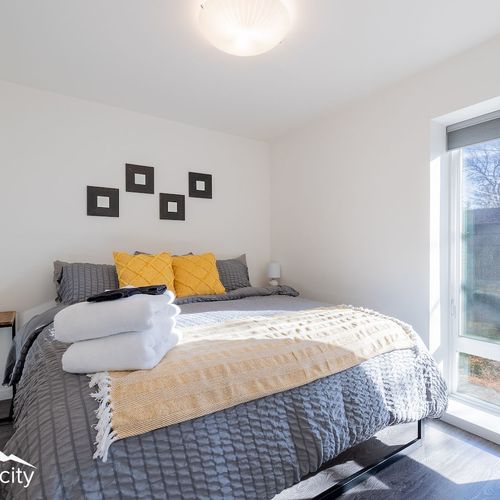 - sink into a cozy comfortable bed layered with fresh linens and colorful accent pillows
- start your day with gentle sunlight streaming through stylish windows
- modern design meets comfort in this tranquil and inviting bedroom retreat