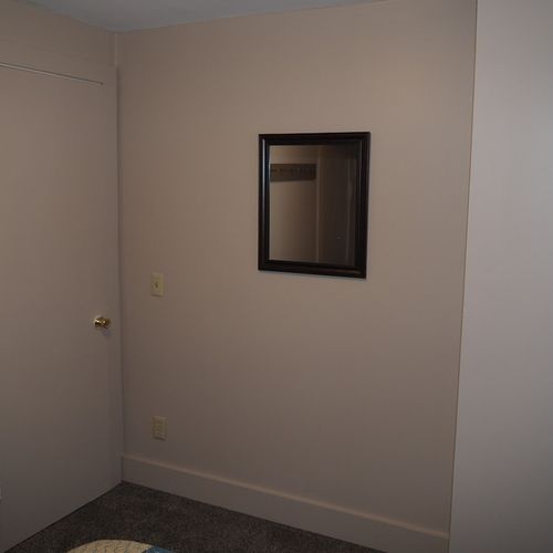 Bedroom #2:  features 2 twin beds, window a/c unit, nightstand, lamp, and mirror.