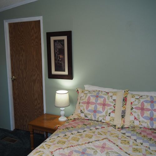 Bedroom #2:  one of the two full-size beds in the bedroom and the bedroom door.