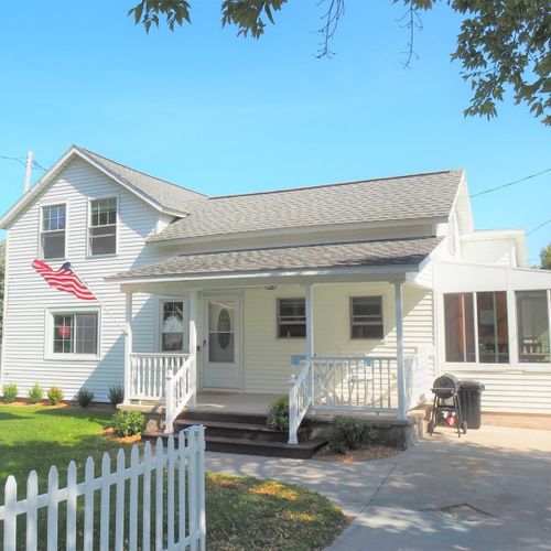 Exterior:  the driveway and front porch in summer.