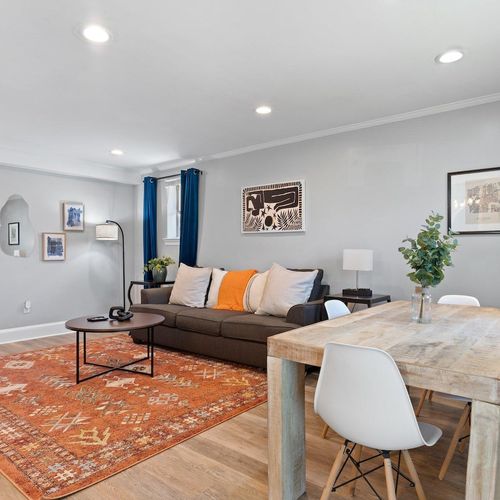 Airy living & dining space w/ natural light & stylish pops of color.