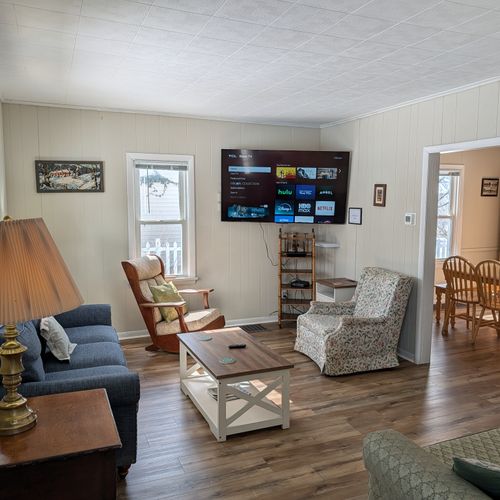 LIVING ROOM:  Very comfy and cozy living room with 2 sofas, a futon, a rocking chair, coffee table, new flooring, and new live streaming television.
