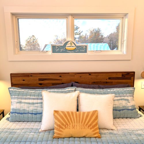 BEDROOM #3 (UPPER LEVEL):  Gorgeous top floor (third floor) bedroom with a king-size bed, nightstands, nightlamps, private television, dresser. closet, amazing view of Crystal Lake, and private entrance to the top floor bathroom!