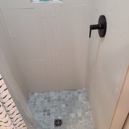 Bathroom #2:  second full bathroom that also serves as the laundry room having a stacked washer and dryer in it.