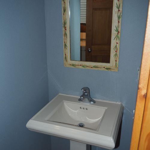 Bathroom #2 (main floor):  half bathroom on the main floor with a sink, shower, and a washer and dryer.
