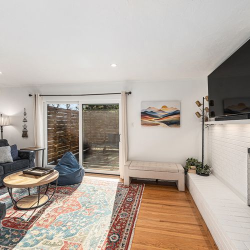 Bright living area with sliding doors that open up to a spacious deck, perfect for indoor-outdoor living.