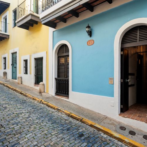 Experience a cozy stay in our vibrant blue AirBNB, nestled in a historic neighborhood with a quaint cobblestone street entrance and a charming traditional balcony. Perfect for an authentic getaway!