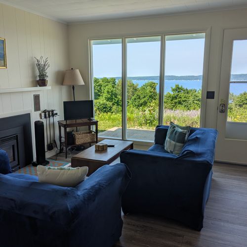 LIVING ROOM:  The home has a comfy living room that includes a wood fireplace and a television.