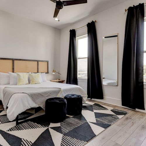 Cozy en suite bedroom w/ large closet & stylish dark curtains.