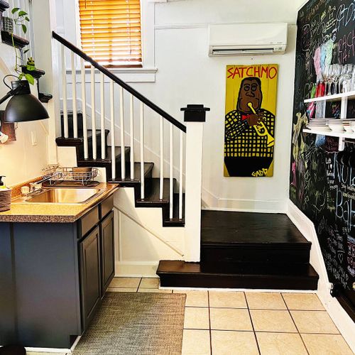 Kitchen sink area w/ a staircase leading up to the bedrooms & bathroom.