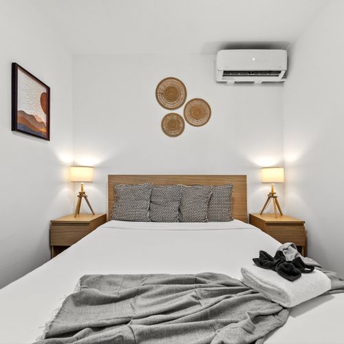 This inviting bedroom offers the perfect retreat with air conditioning.